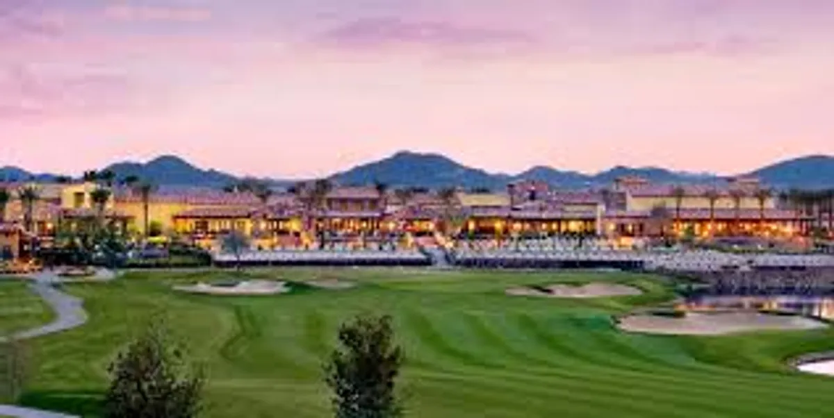 A scenic view of the community's golf course with a clubhouse in the background, set against a stunning mountain backdrop. Comfortable outdoor seating areas invite residents to gather and enjoy the outdoors, whether dining, socializing, or simply taking in the sunset.